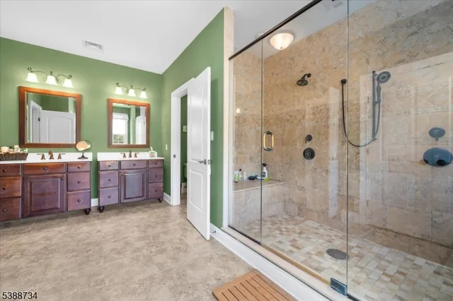 a bedroom with a bed a chandelier and balcony