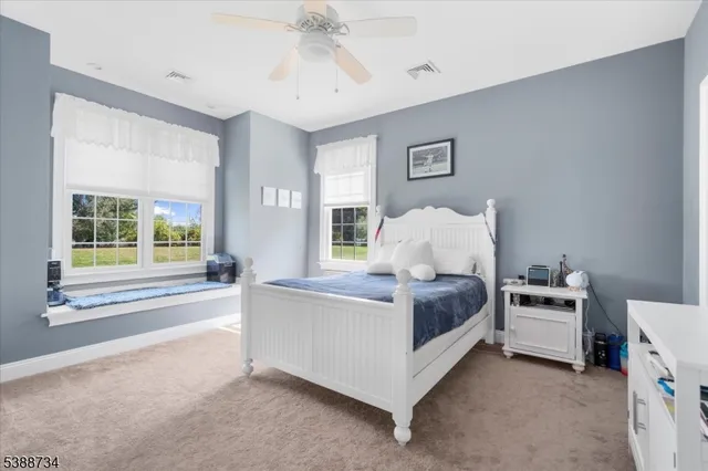 a bathroom with a sink vanity mirror and toilet