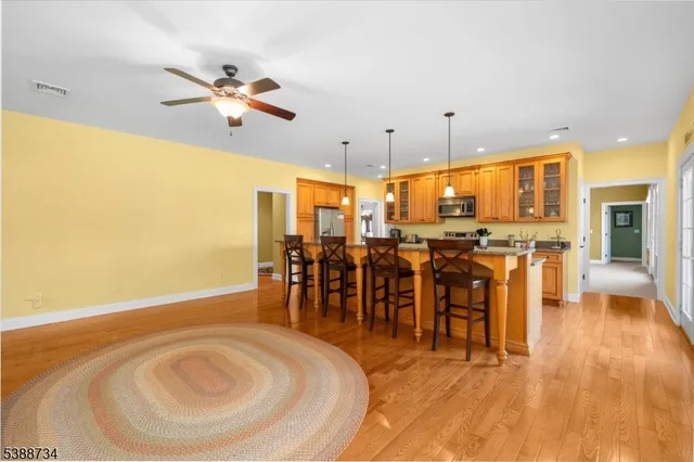 a living room with furniture pool table and a flat screen tv