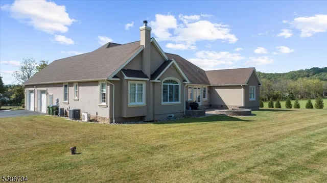 a view of a house with a yard and sitting area