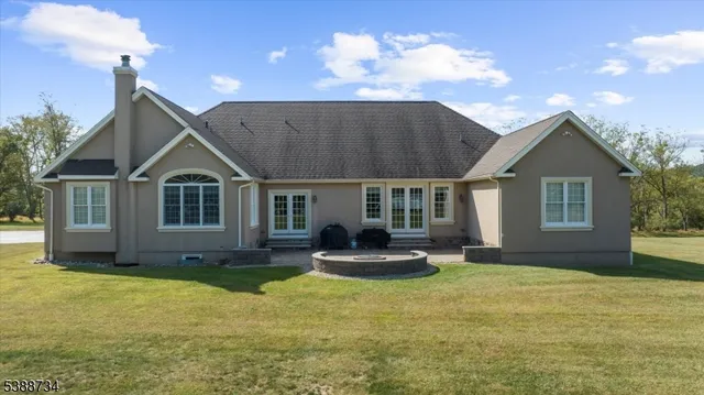a front view of a house with a yard outdoor seating and garage