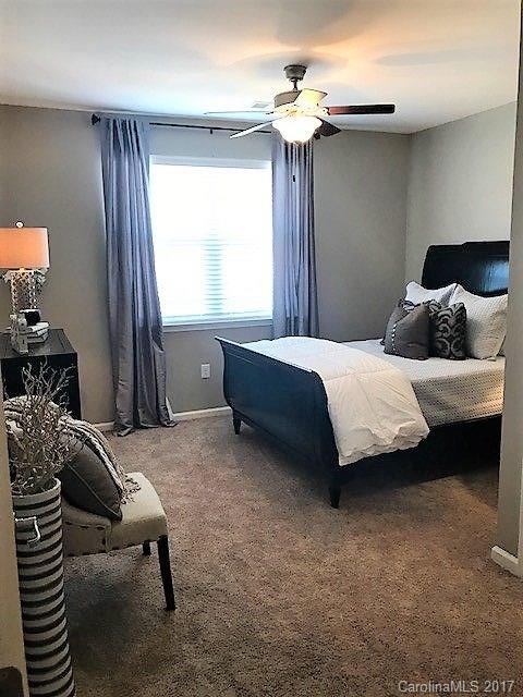 355 Amistead Avenue Fort Mill, SC 29708 - Photo 12 of 23 a bedroom with a bed and a chandelier