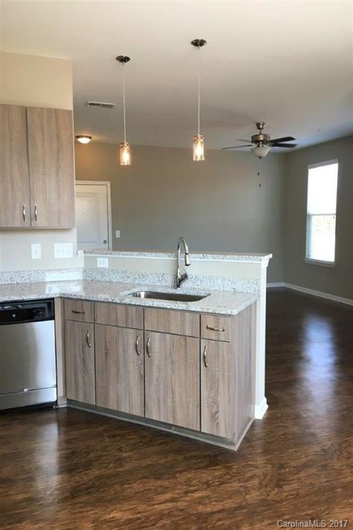 355 Amistead Avenue Fort Mill, SC 29708 - Photo 20 of 23 a kitchen with stainless steel appliances granite countertop a sink a stove a counter space and cabinets