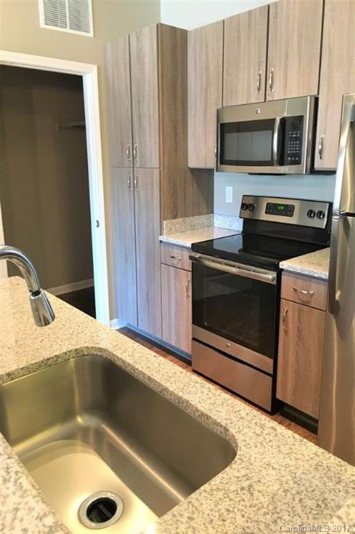 355 Amistead Avenue Fort Mill, SC 29708 - Photo 21 of 23 a kitchen with a sink a microwave and cabinets