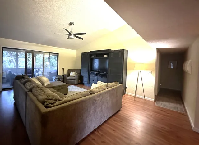 a bedroom with a bed a couch and a chandelier