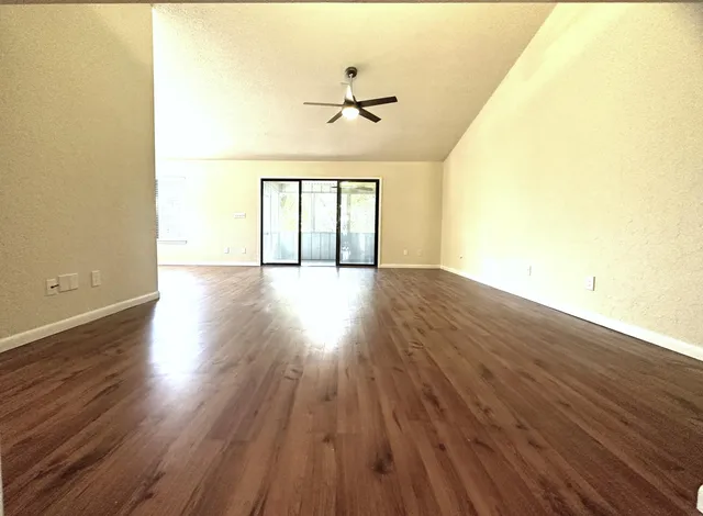 a view of balcony with wooden floor and fence