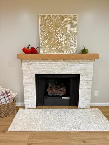 a living room with a fireplace and a wooden floor