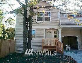 a view of a house with a small deck and a yard