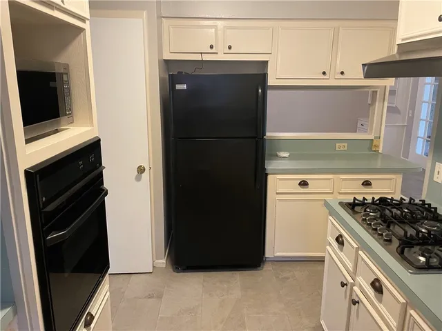 a kitchen with a refrigerator stove and microwave