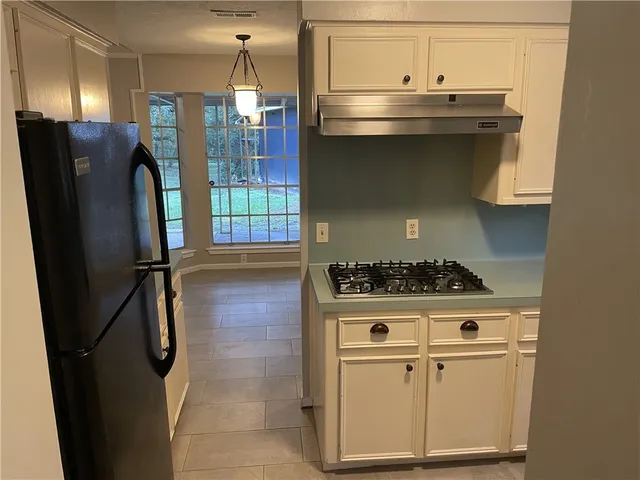 a stove top oven sitting inside of a kitchen
