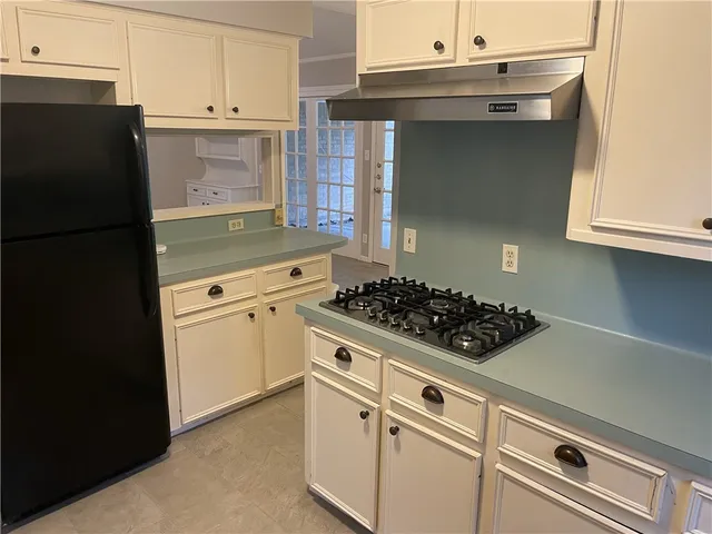 a kitchen with a stove and a refrigerator
