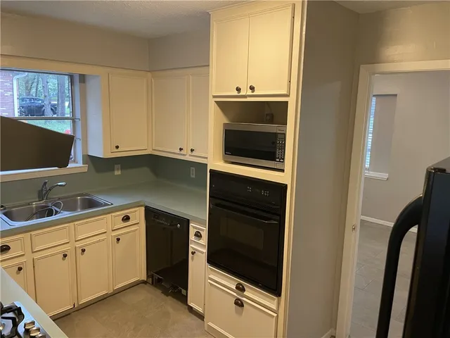 a kitchen with a sink and a microwave