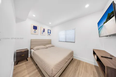 a bedroom with a large bed and a lamp