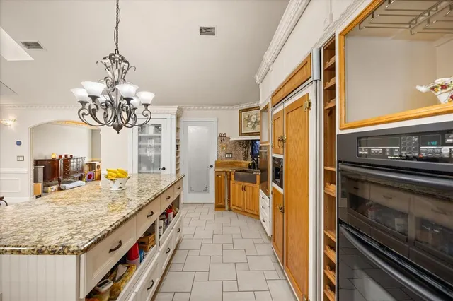 a bathroom with a granite countertop shower a mirror and a sink