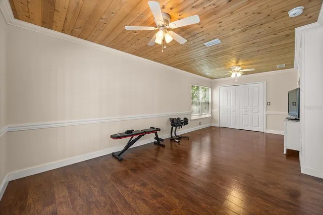 a view of a patio with a table and chairs under an umbrella