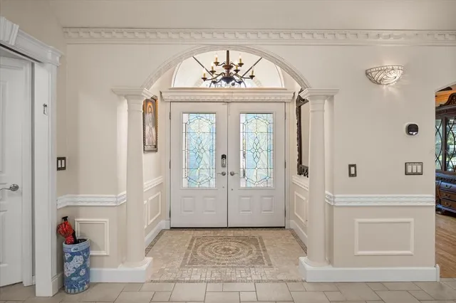 a living room with furniture chandelier and fireplace