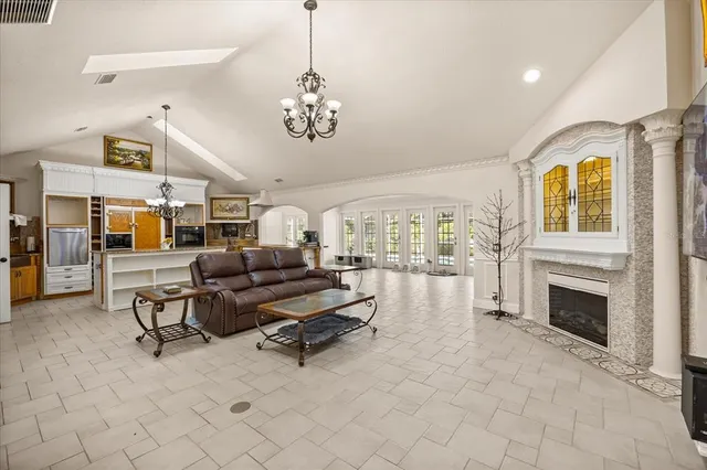 a large kitchen with kitchen island a refrigerator and a stove