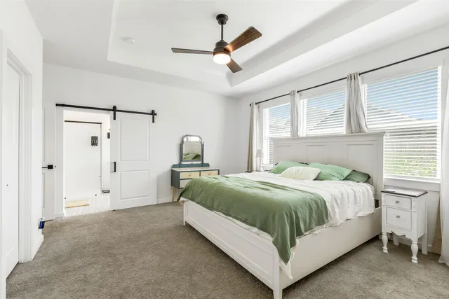 a bedroom with a bed and a chandelier