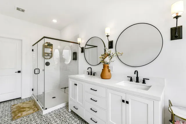 a bathroom with a sink a mirror and a shower