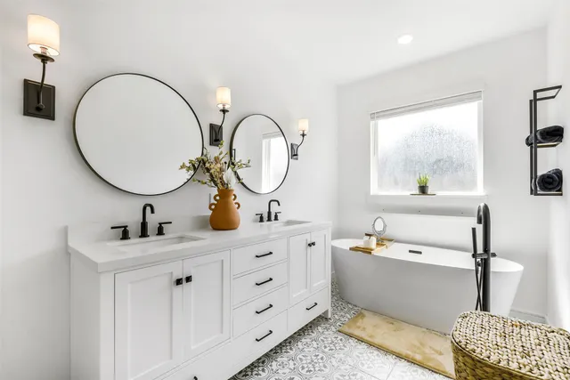 a bathroom with a double vanity sink and a mirror