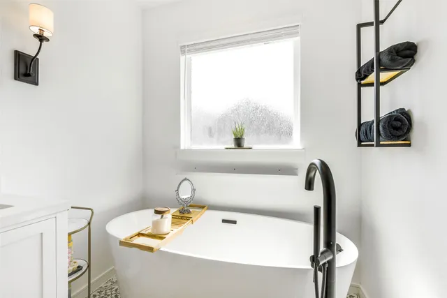 a bathroom with a sink and a window