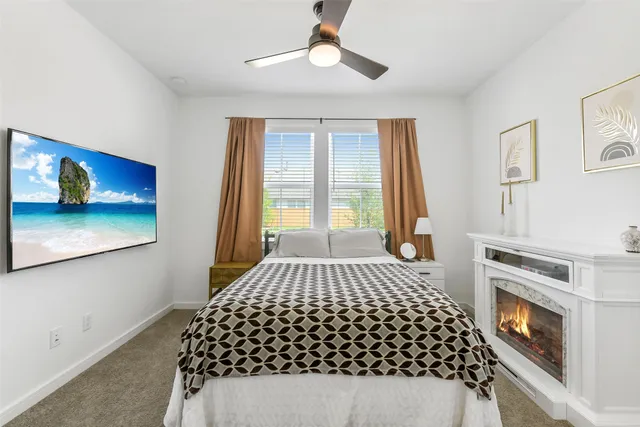 a bedroom with a bed and a fireplace