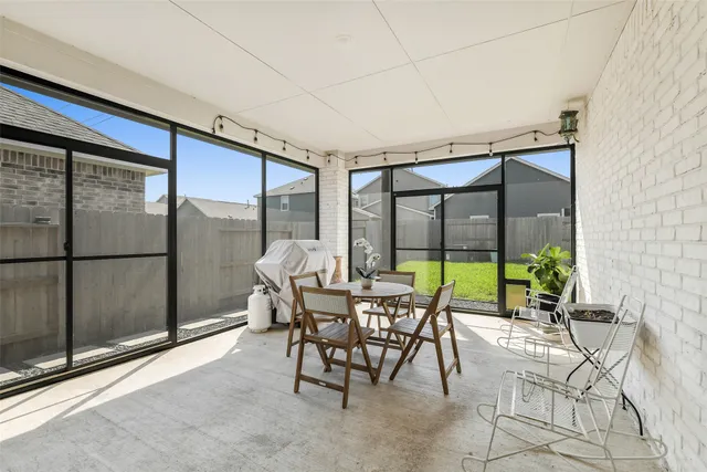 a dining room with furniture and floor to ceiling window