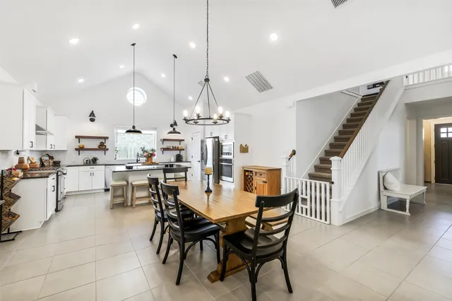a large kitchen with a table and chairs