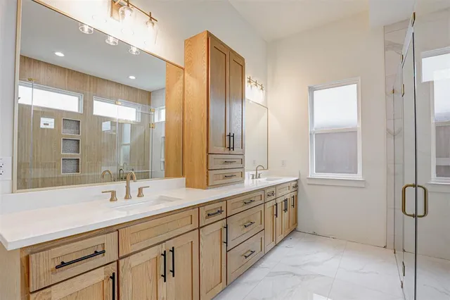 a bathroom with double vanity sinks double vanity and a shower