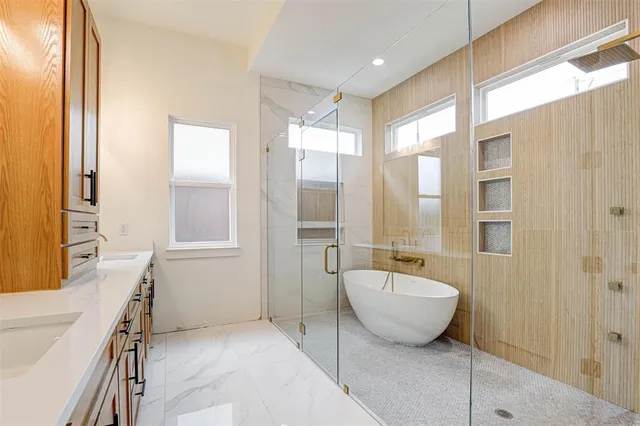 a spacious bathroom with a bathtub and a sink
