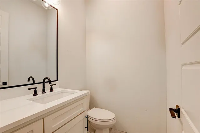 a bathroom with a sink a toilet and mirror