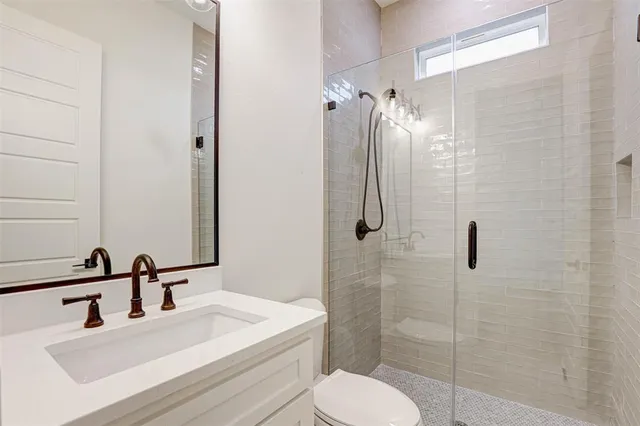 a bathroom with a sink toilet and shower