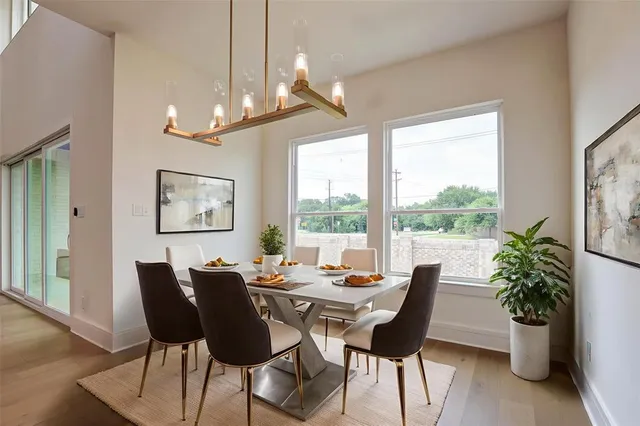 a view of a dining room with furniture window and wooden floor