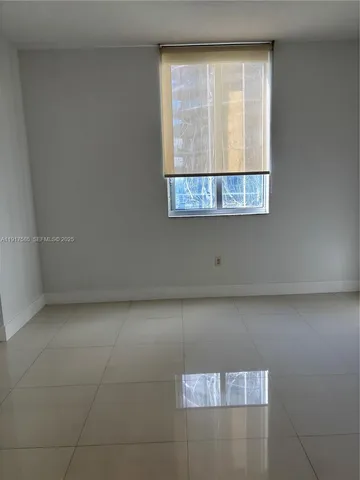 a view of wooden floor and cabinet in an empty room