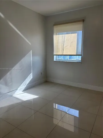 a view of a livingroom with an empty space and window