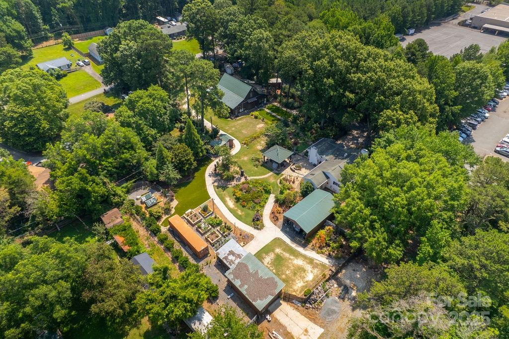 an aerial view of residential houses with yard