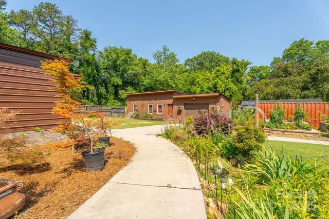 a view of a swimming pool with a patio and a garden