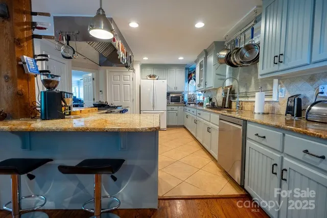a kitchen with refrigerator and cabinets