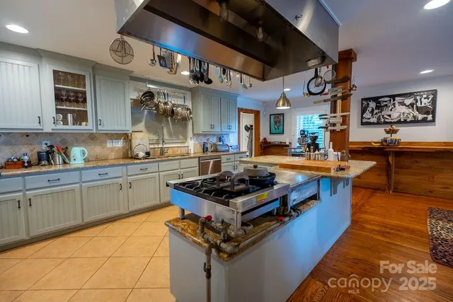 a living room with furniture a fireplace and a window