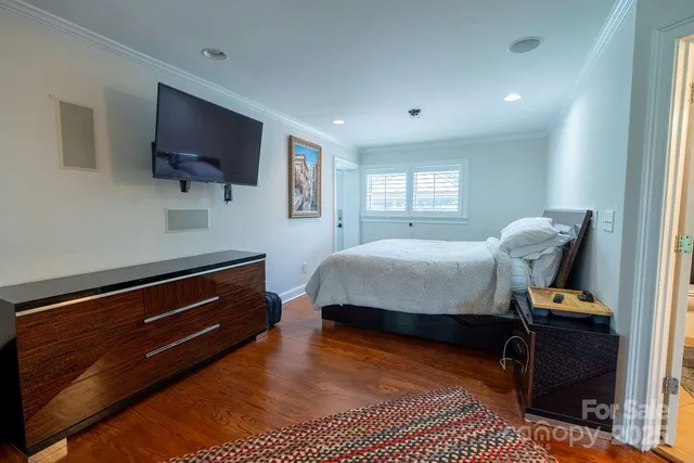 a spacious bedroom with a bed and dresser