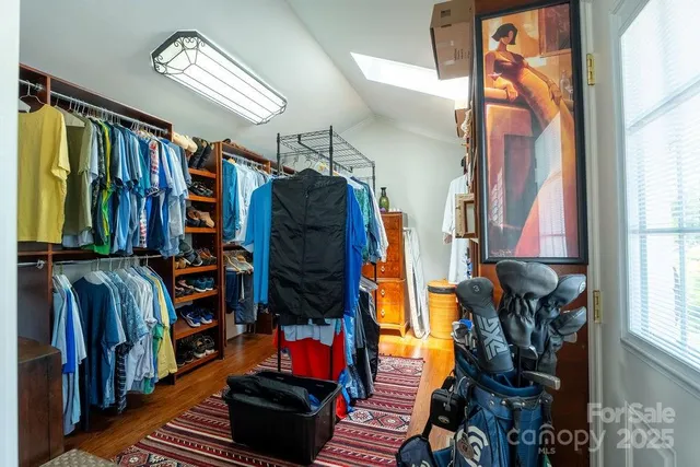 a room with pool table and wooden floor