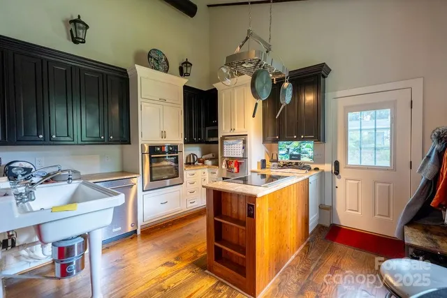a bathroom with a granite countertop sink a mirror and shower
