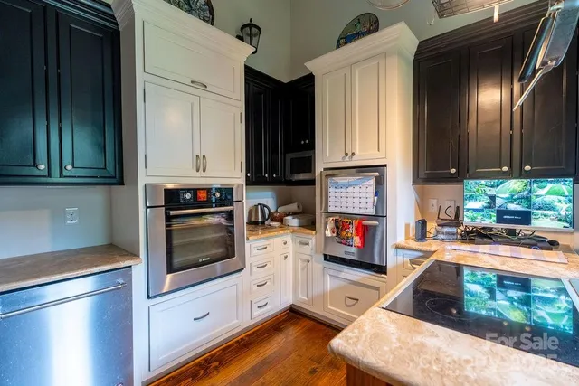 a spacious bedroom with a bed dresser and a large window