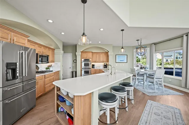 a large kitchen with a table and chairs