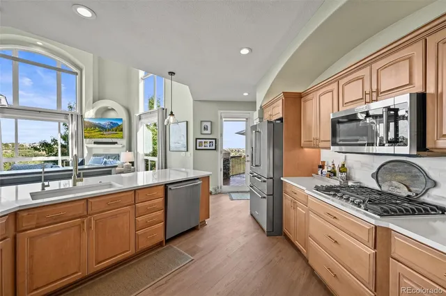 a kitchen with stainless steel appliances a sink stove and refrigerator