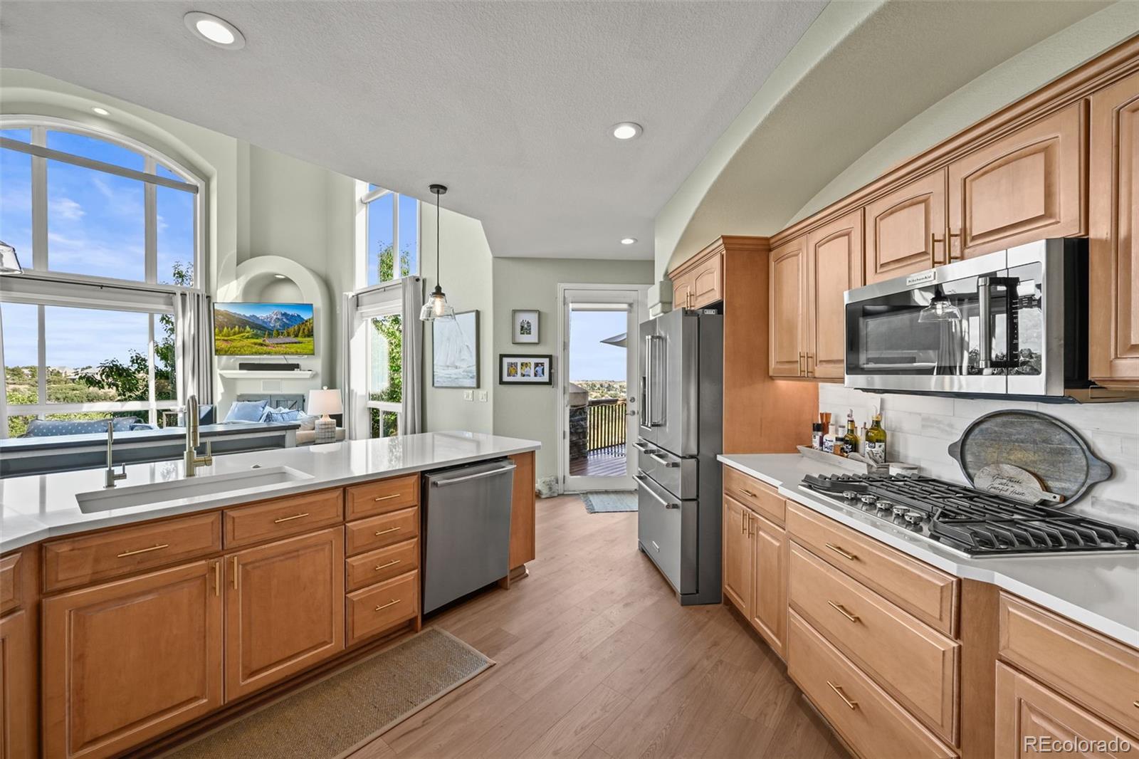 1289 Diamond Ridge Circle Castle Rock, CO 80108 - Photo 13 of 50 a kitchen with stainless steel appliances a sink stove and refrigerator