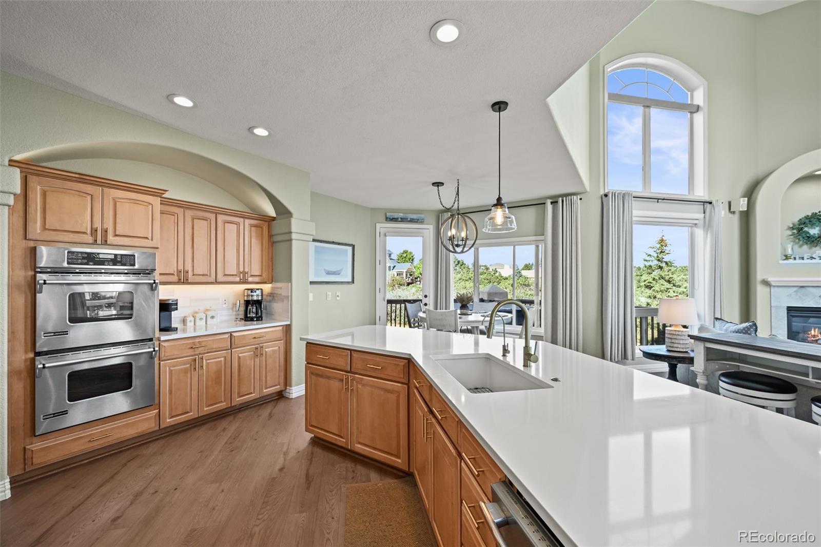 1289 Diamond Ridge Circle Castle Rock, CO 80108 - Photo 14 of 50 a kitchen with stainless steel appliances a sink a stove a refrigerator cabinets and a window