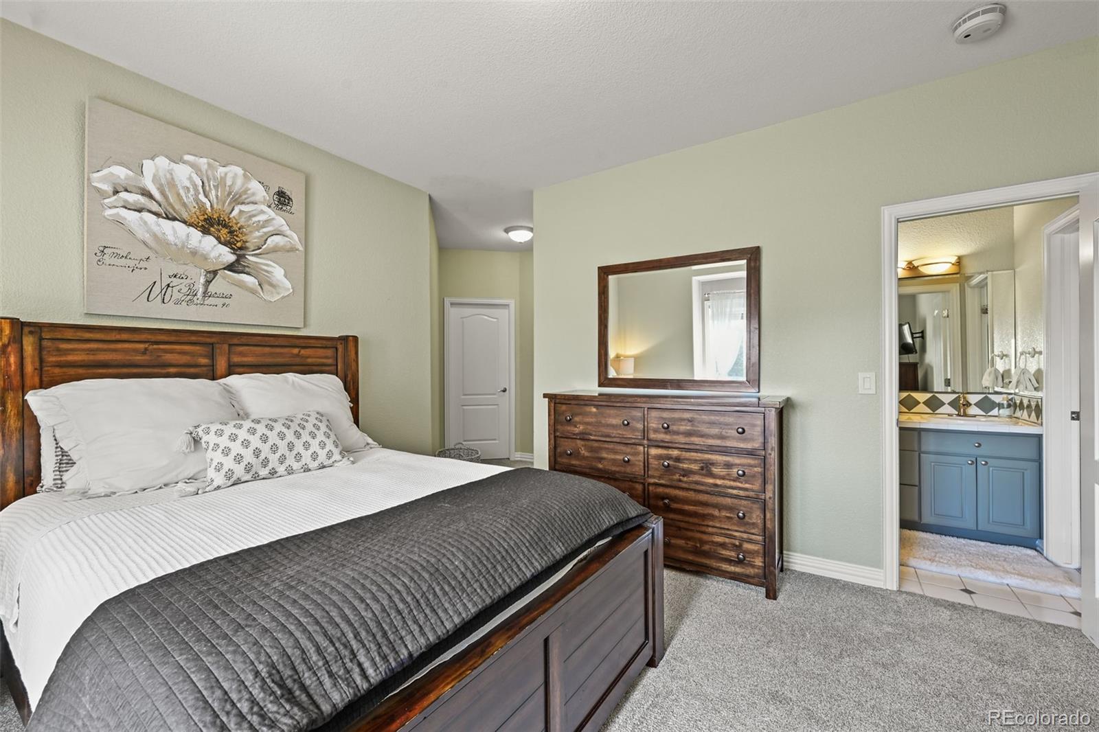 1289 Diamond Ridge Circle Castle Rock, CO 80108 - Photo 24 of 50 a bedroom with a bed and a chandelier