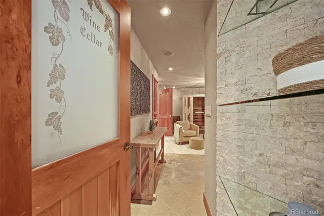 a kitchen with stainless steel appliances granite countertop a stove top oven a sink dishwasher a dining table and chairs with wooden floor