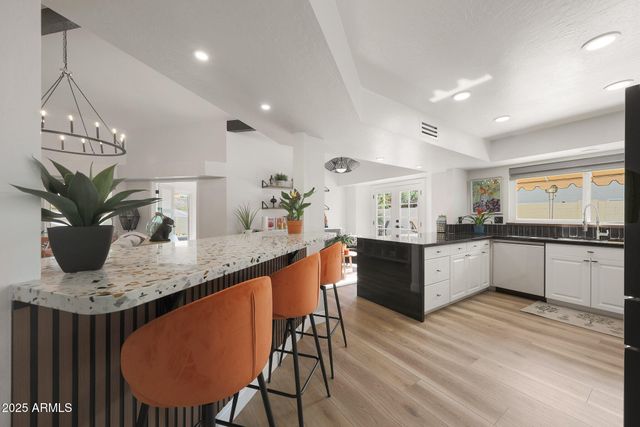 a dining room with furniture and a chandelier